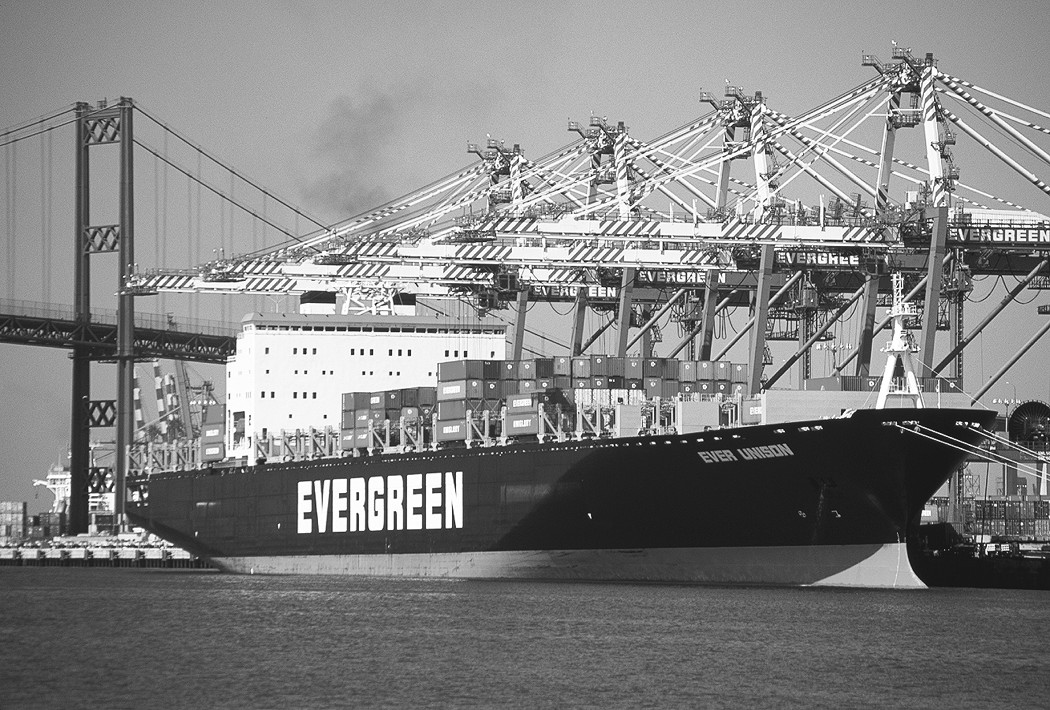 Figure 15-7: A container ship unloads at port.